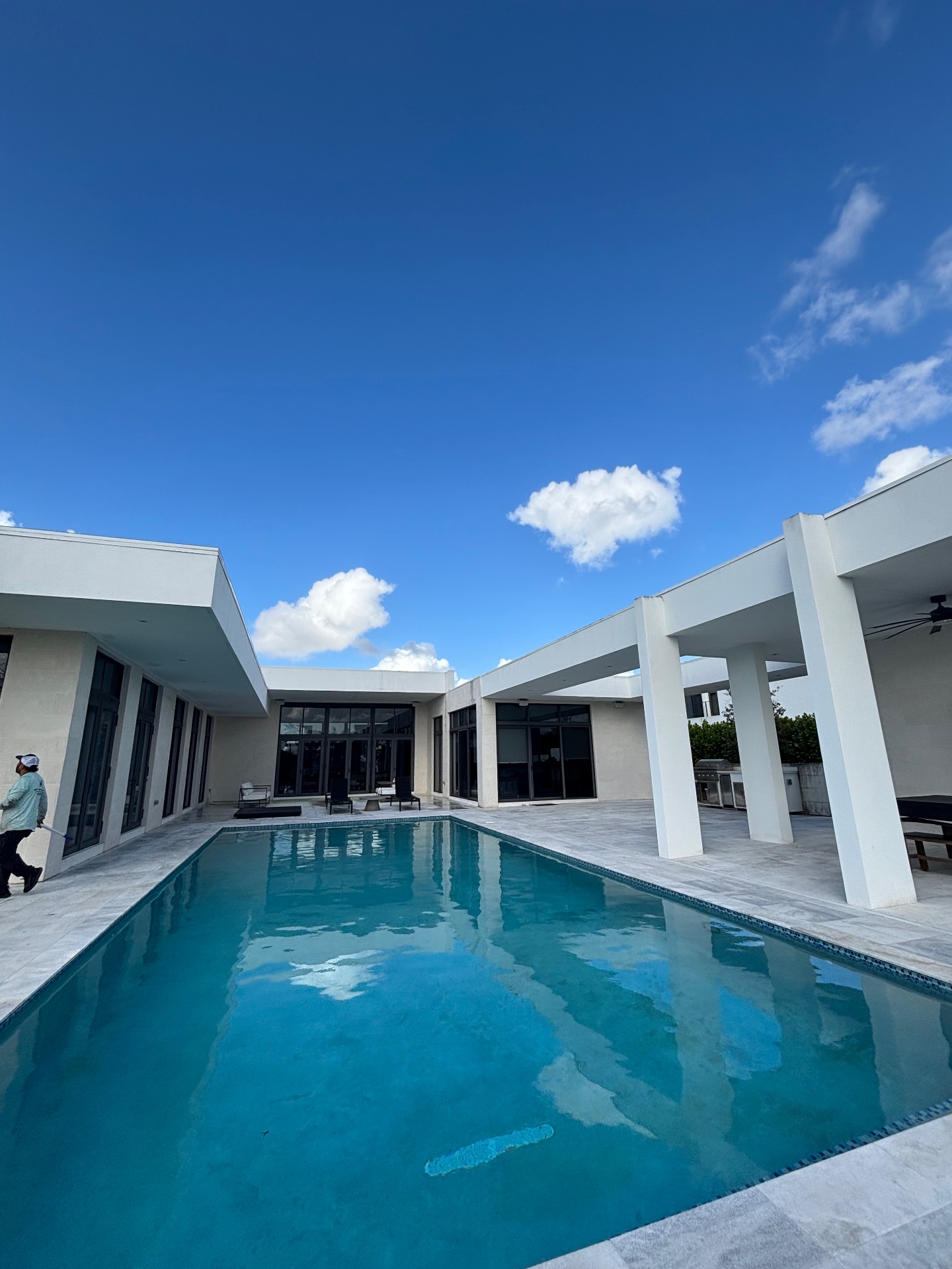 Aerial view of a pristine South Florida home with cleaned tile roof and pool